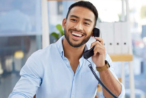 man at desk talking on phone